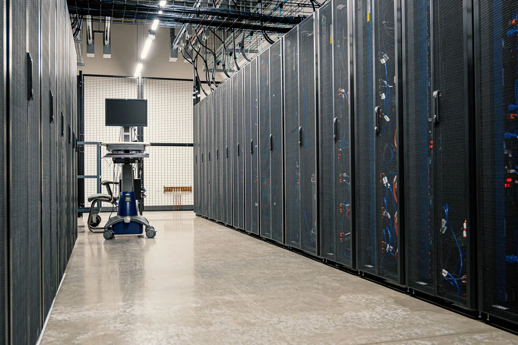 A long aisle of server racks inside a data centre